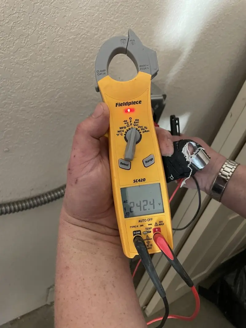 Voltage testing with clamp meter during Ceiling Fan Installation in Porters Neck